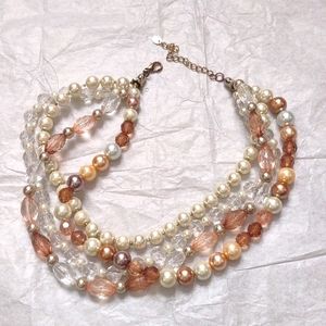 Multi strand Necklace With earrings Colors include Pearl, clear, brown and tan.